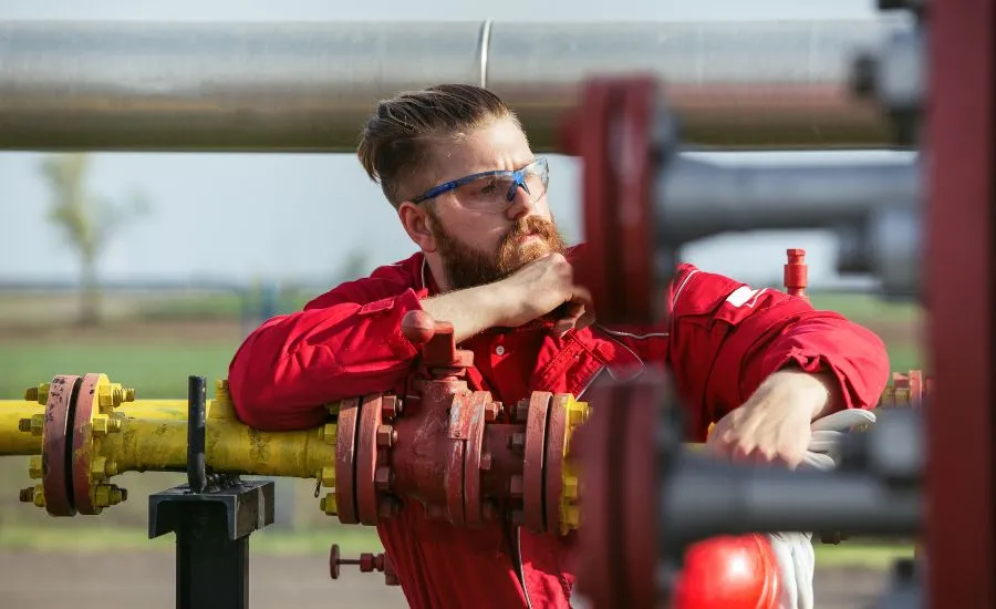 A worker surveying the pipes used for oil and gas industry